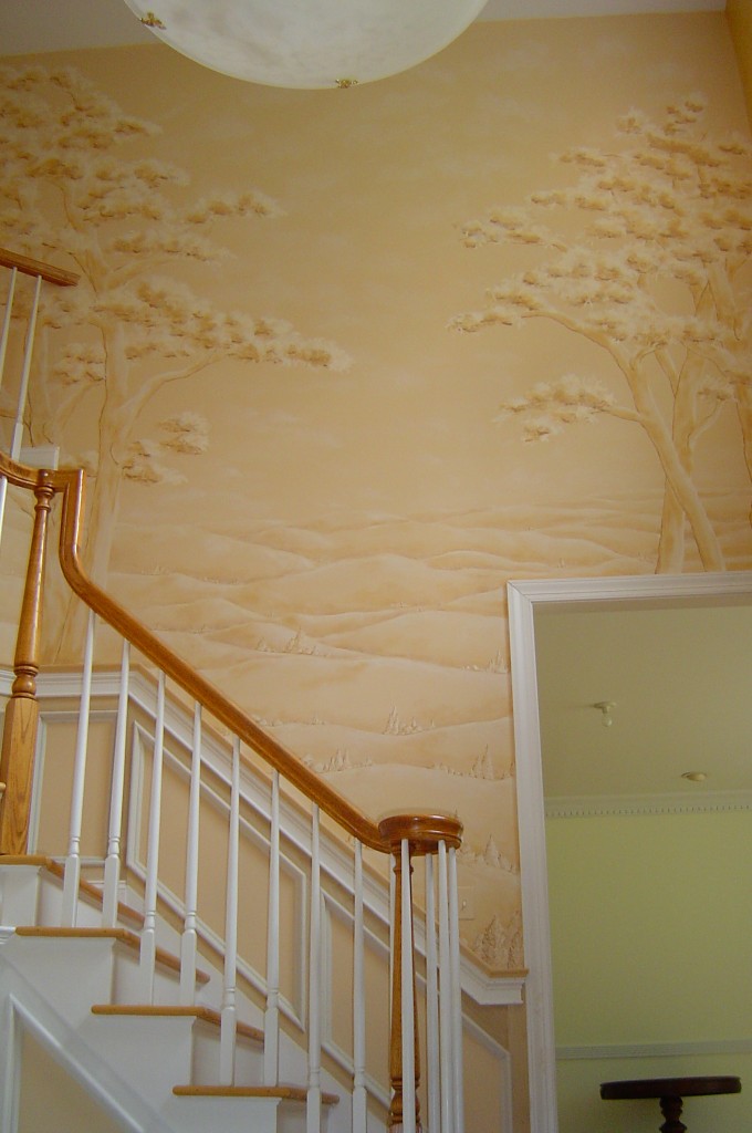 Monochromatic landscape mural painted on two-story foyer wall.