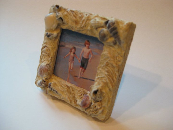 Plaster finish with embedded shells and glaze finish on small frame.