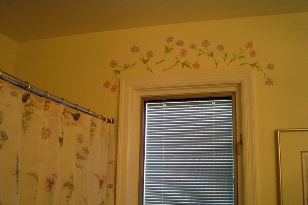 Decorative floral accents painted above the window to coordinate with Bathroom accessories.