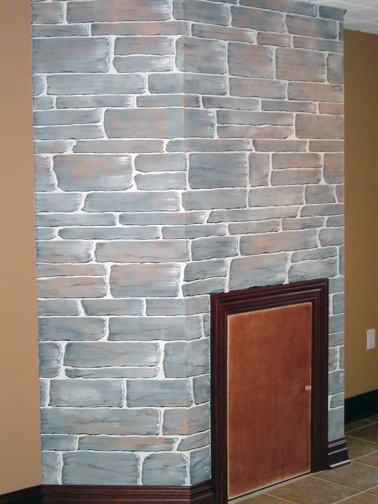 False fireplace accent wall painted to replicate actual stone fireplace wall elsewhere in the home.