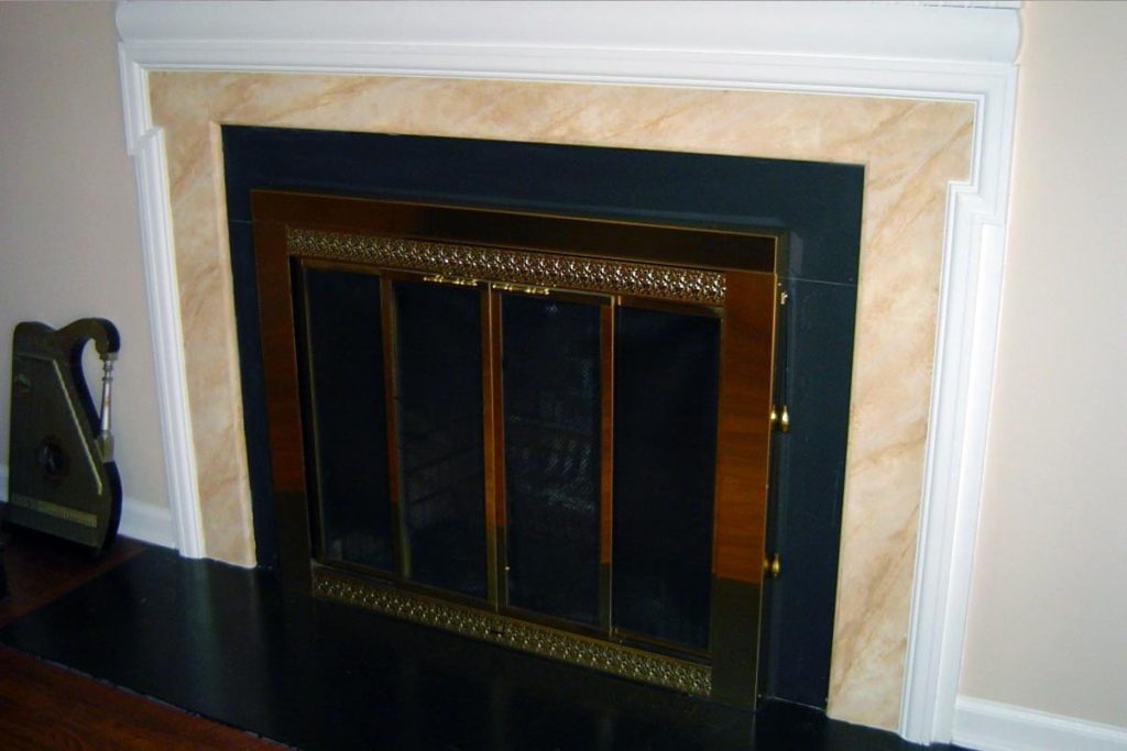 Mantle inset is painted to replicate marble.