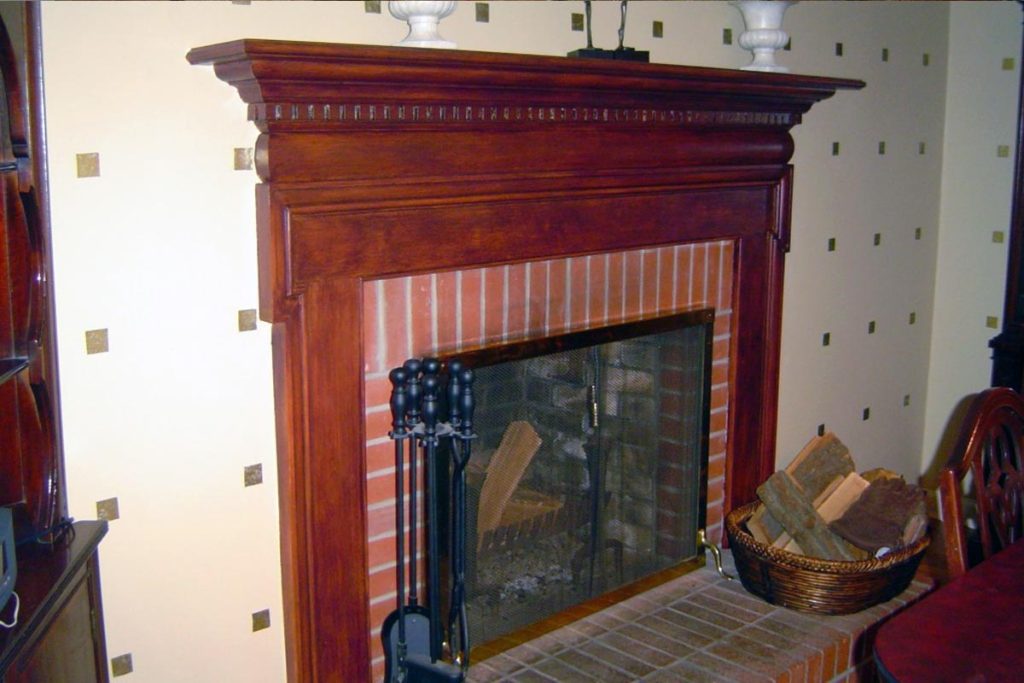Fireplace surround painted to replicate red mahoghany