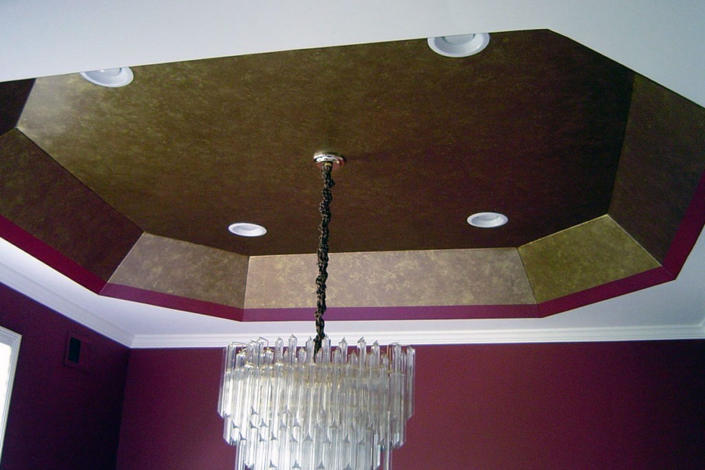Painted gold “leaf” finish within tray ceiling in dining room.