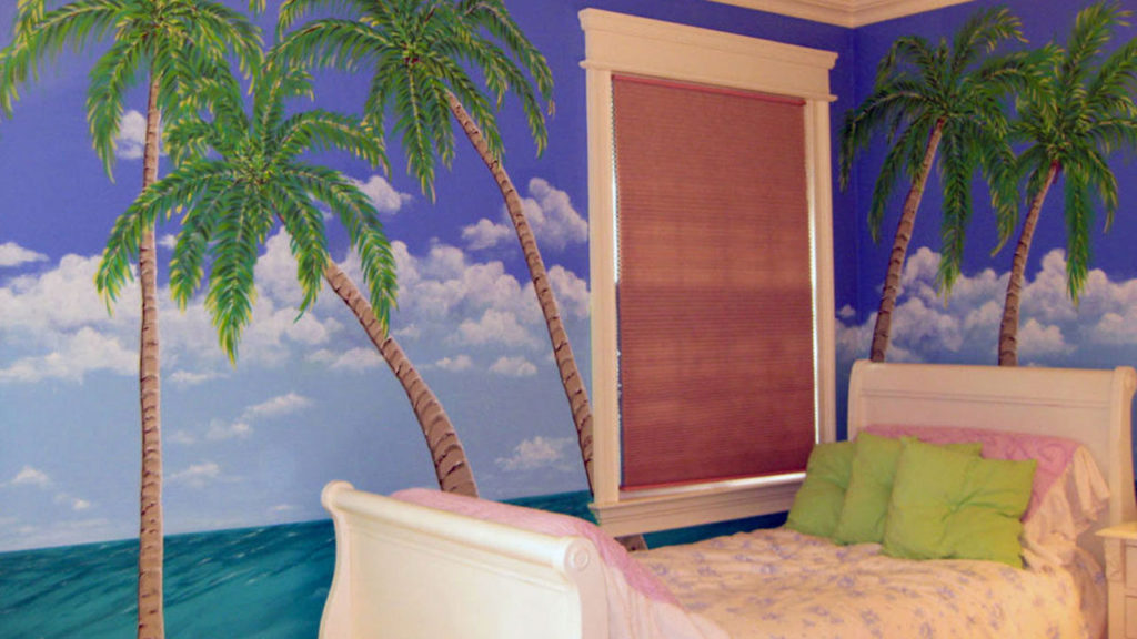 Ocean view with palm trees painted in teen’s bedroom.