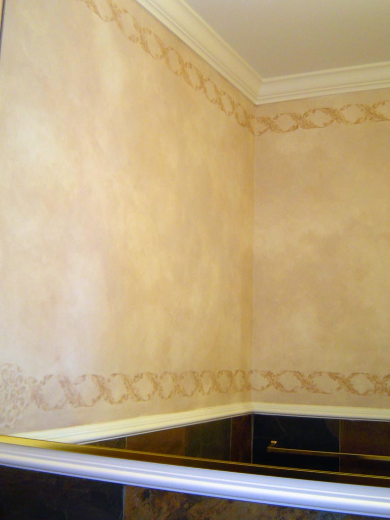 Powder room painted in a blend of taupe colors with an acanthus leaf stenciled border.