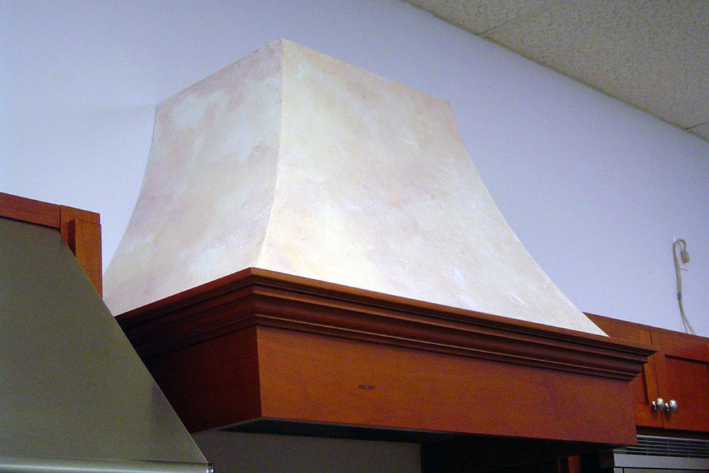Stucco finish applied to kitchen range hood, and painted with stone colorwash finish.