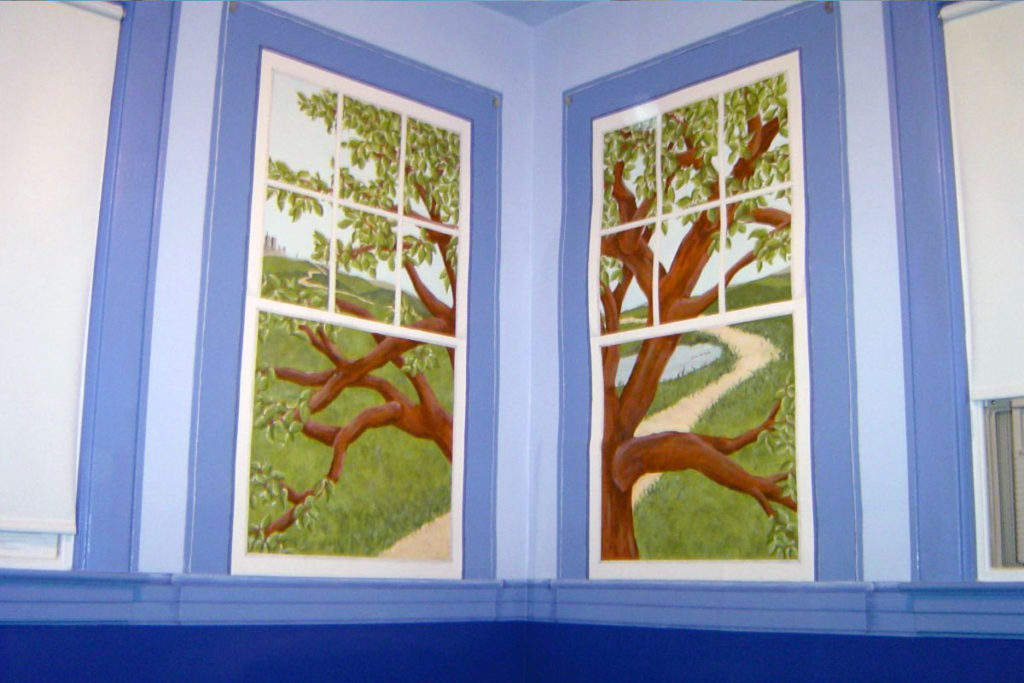 Whimsical outdoor scene painted within trompe-l’oeil window frames that replicate the actual adjacent windows.