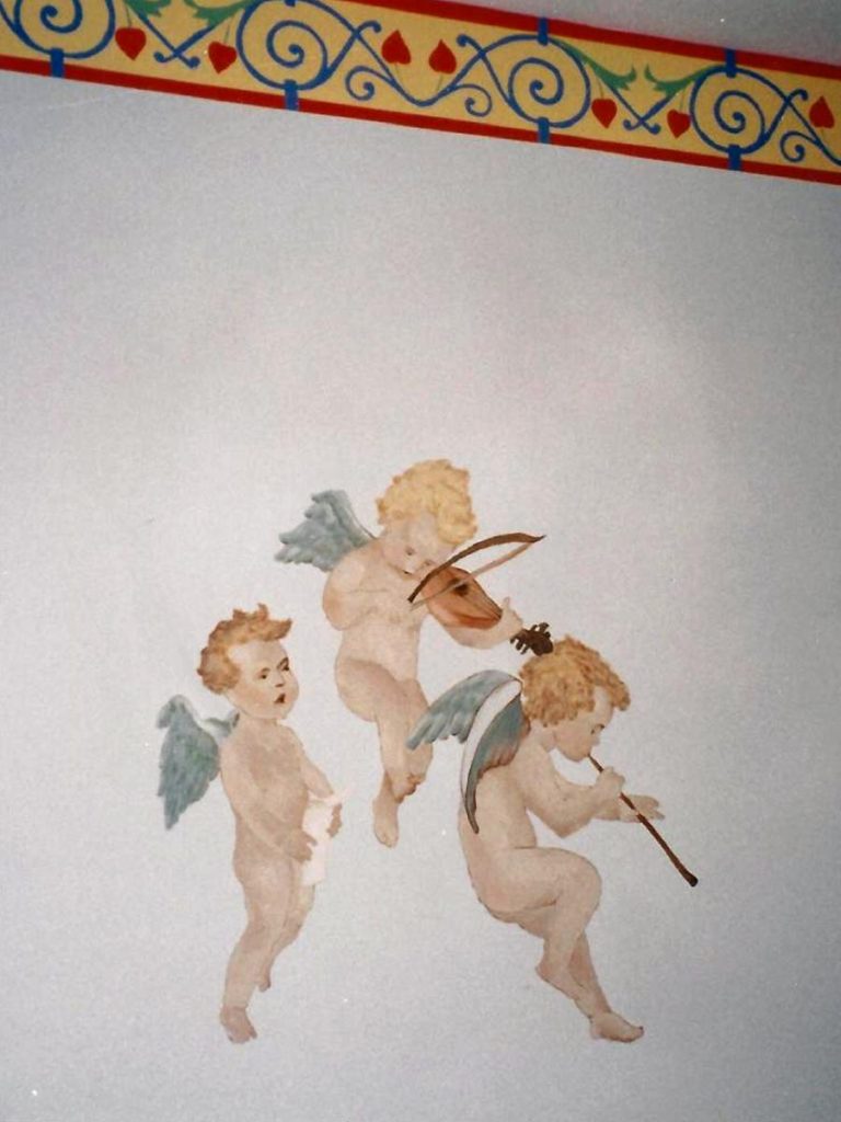 Detail of cupids over the crib.