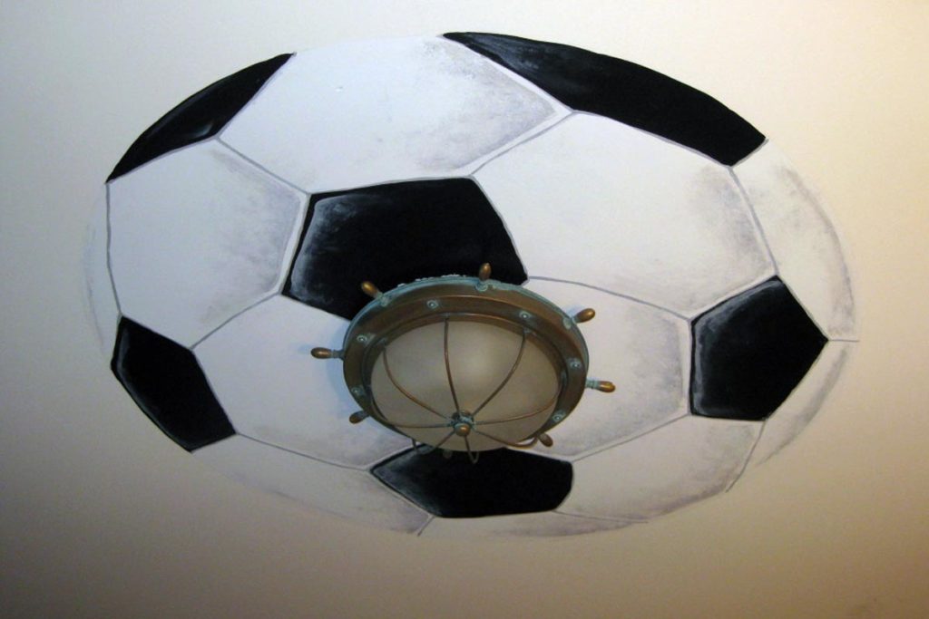 Giant soccer ball painted around light fixture.