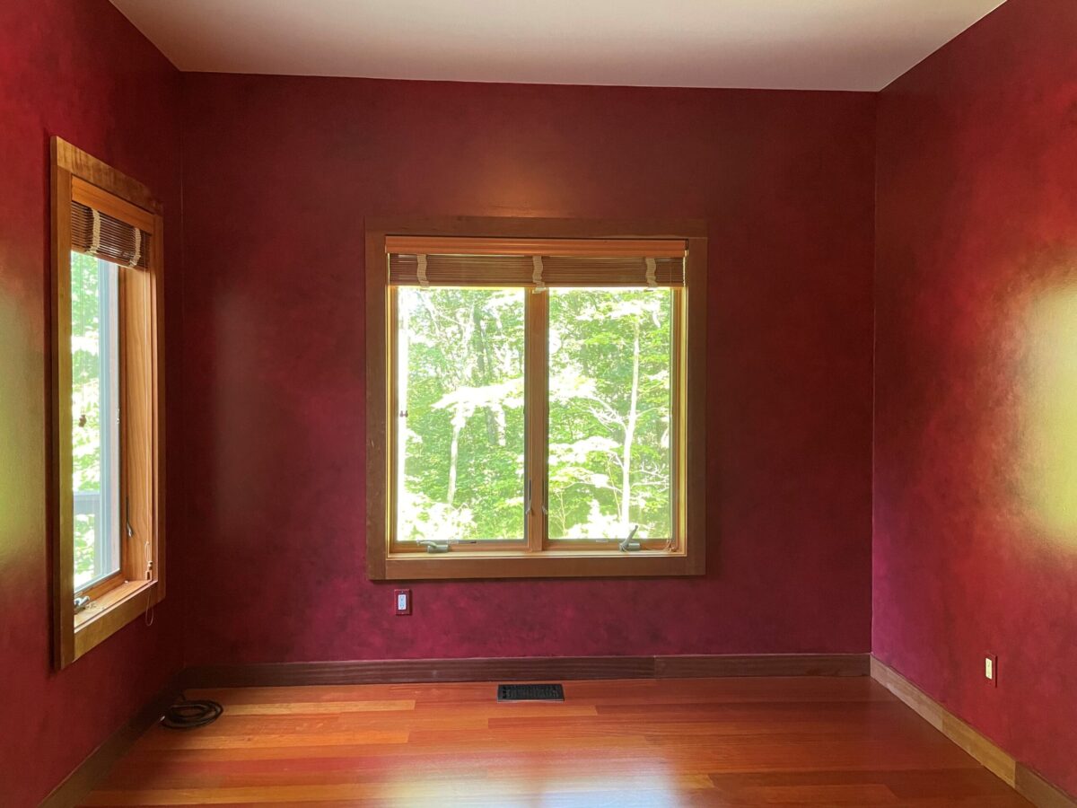 Warm red leather-look glaze painted in library room.