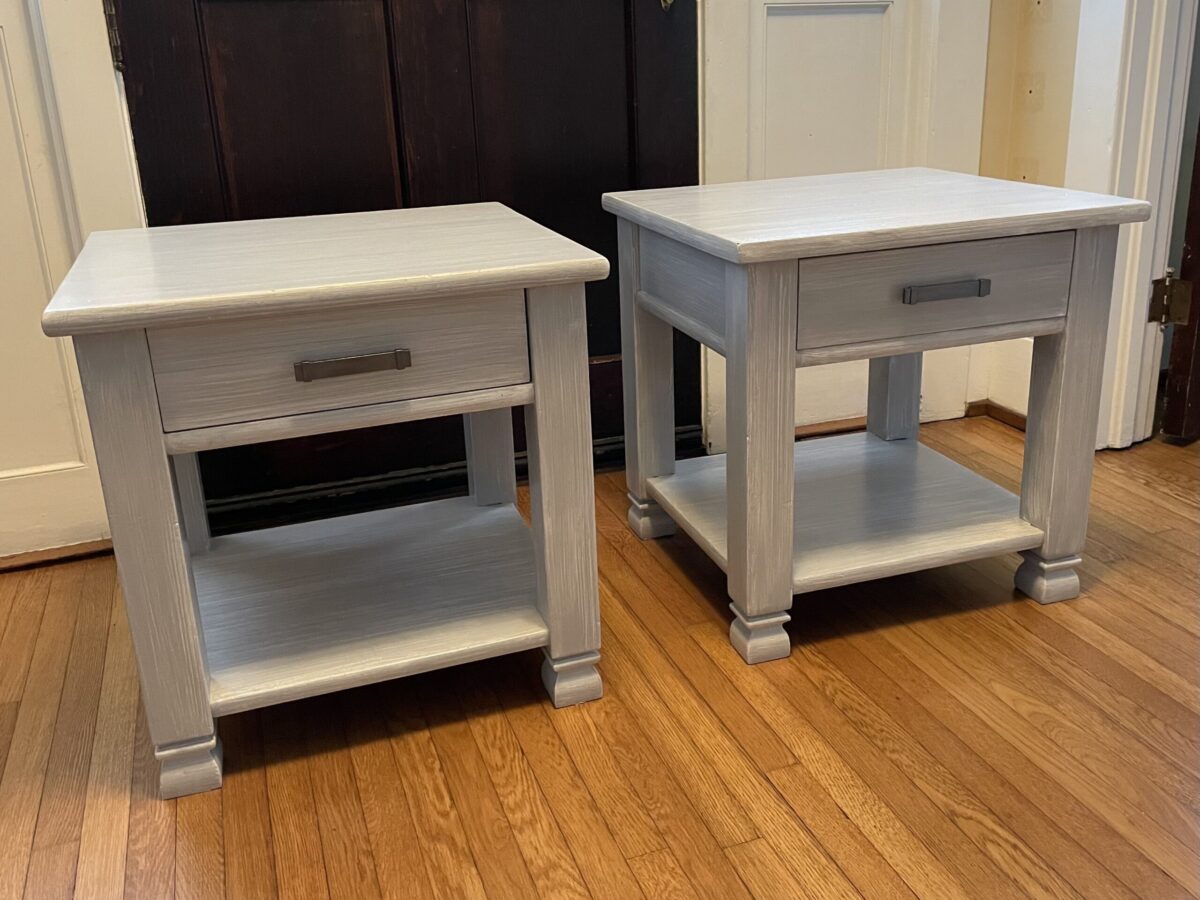 Two dark wood end tables refinished with grey striae.