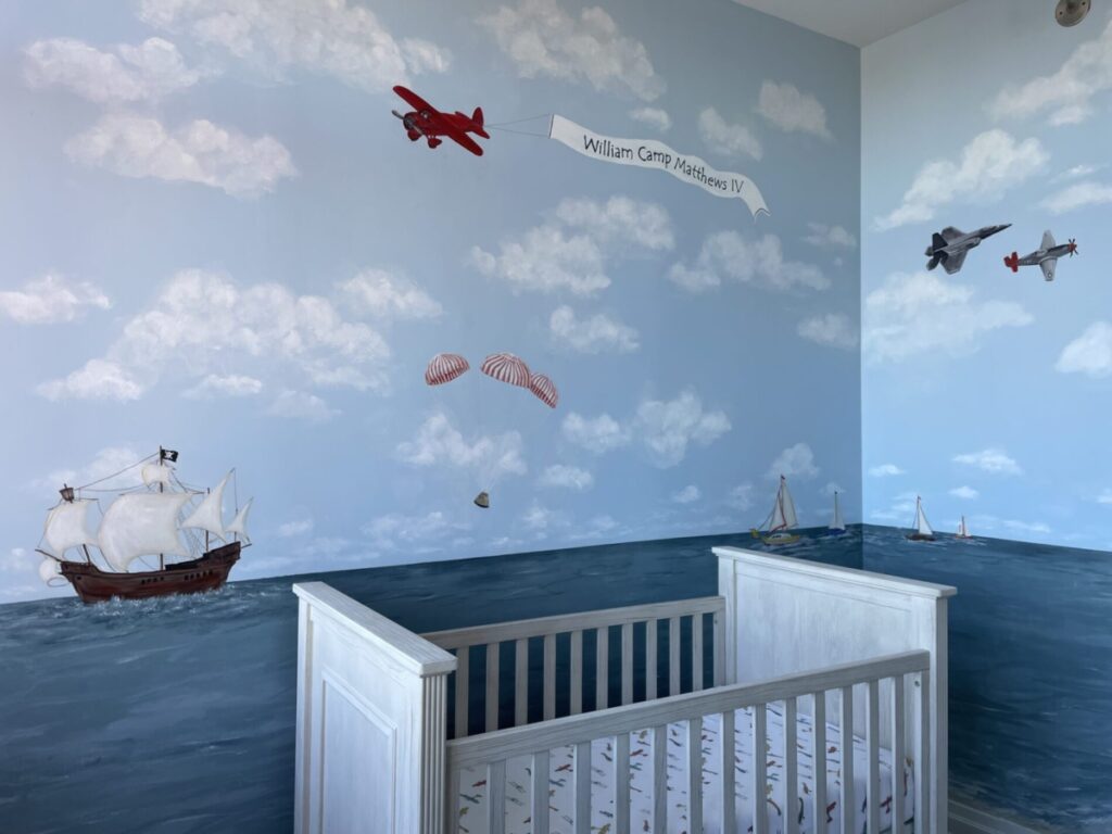 Oceanscape nursery mural with a variety of aircraft and boats.