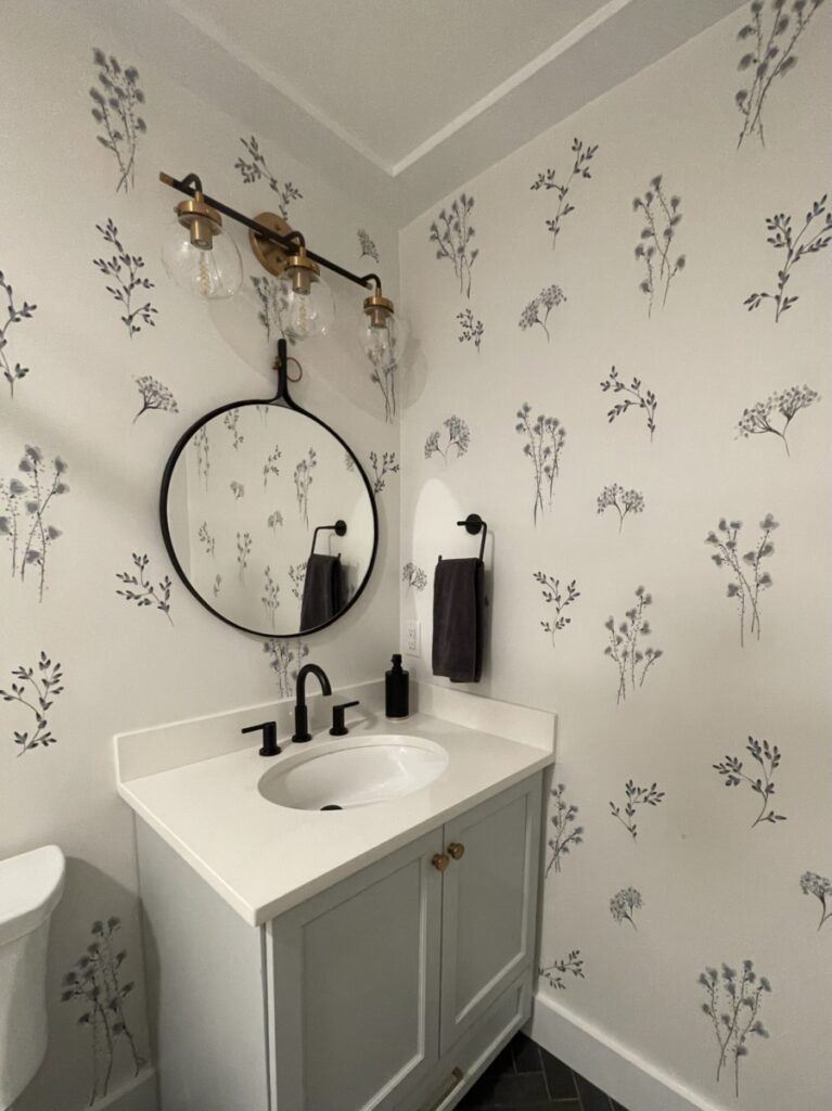 Powder room with wildflower bunches painted in a range of charcoal greys in controlled random pattern.