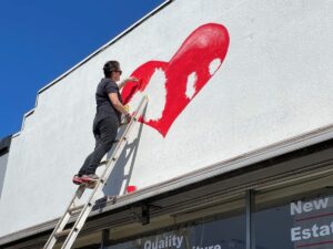 Working on exterior heart and logo painting