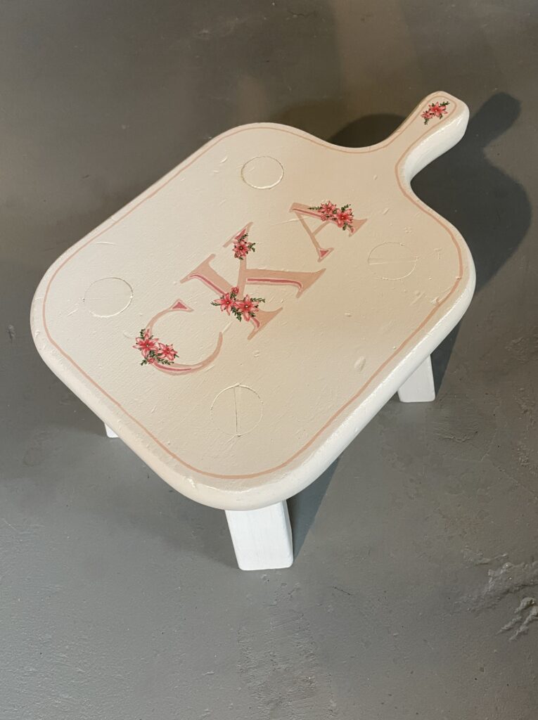 Vintage handmade stool painted white with monogram and flowers.