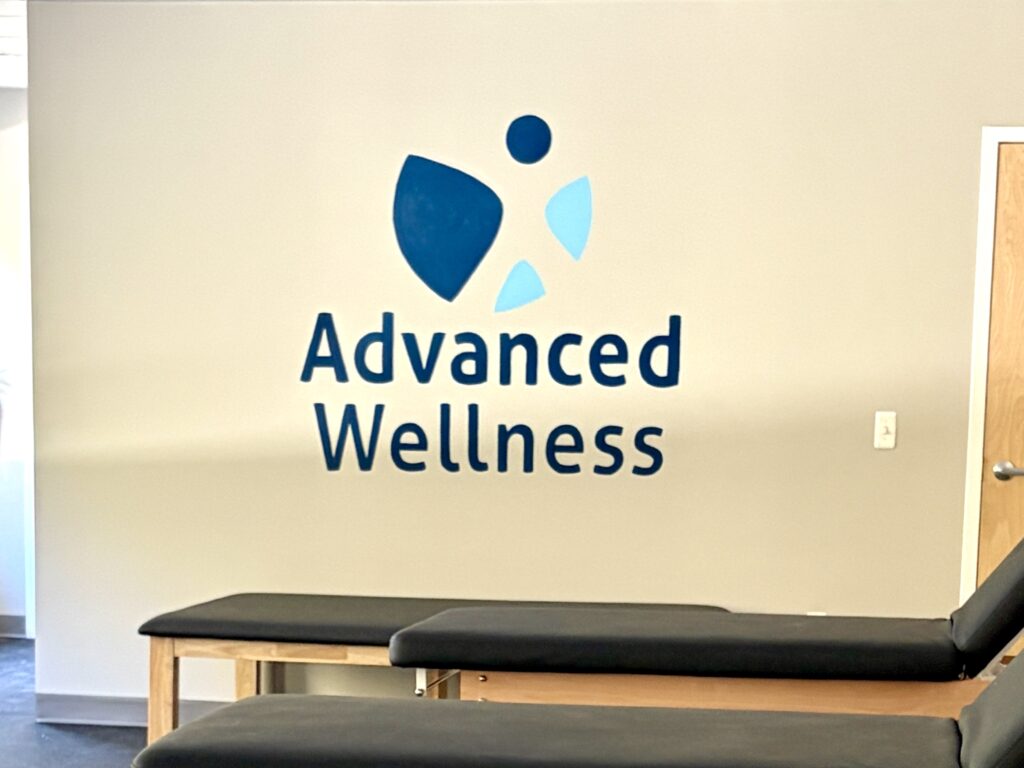 Four foot square logo painted on focal wall of physical therapy practice.