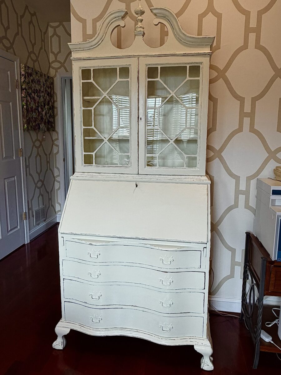 Creamy white paint with antique rub-through on old dark wood secretary desk